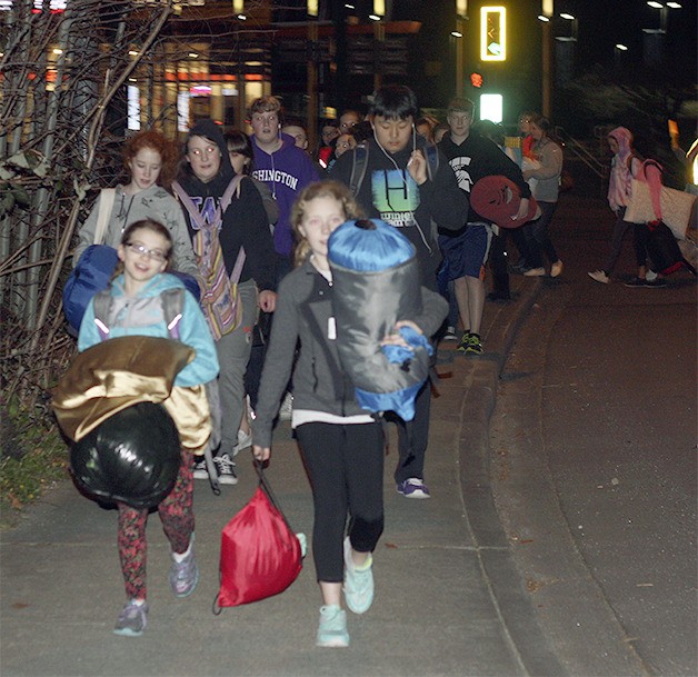 Participants in the 30 Hour Famine come around the bend to Sammamish Presbyterian Church at the end of a nearly 2-mile walk north up 228th Avenue.