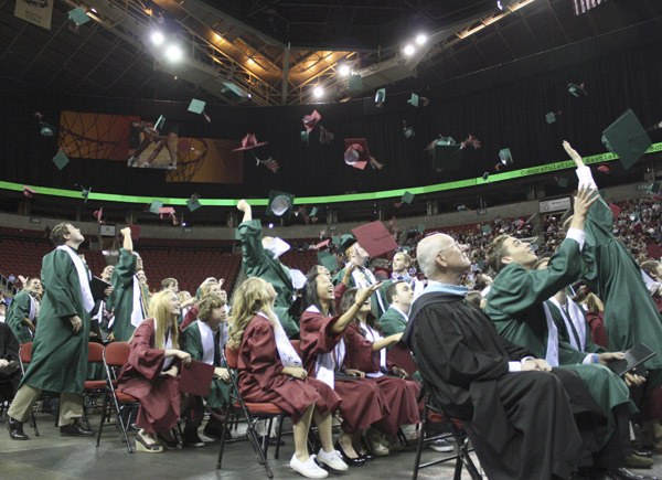 Eastlake grads send their caps into the air Tuesday night at Key Arena.