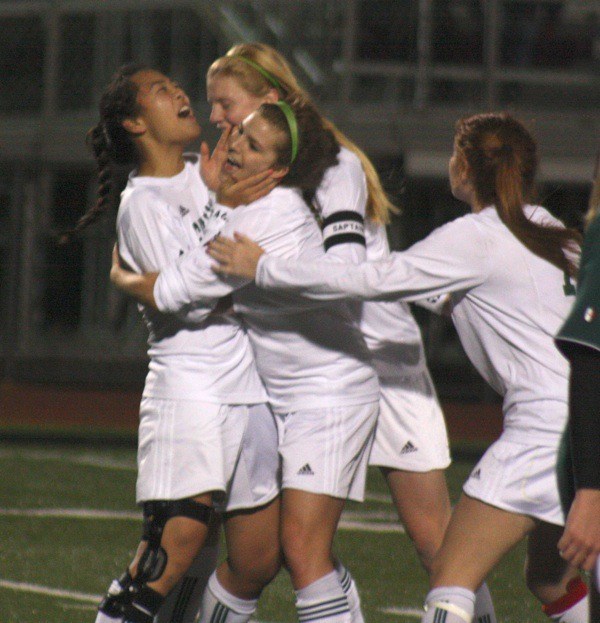 Skyline junior Rachel Shim celebrates with teammates after scoring the winning goal during the 75th minute of Tuesday's state tournament opener against Kentridge.