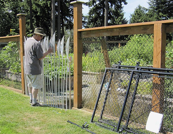 Local artist Garth Edwards installs his new