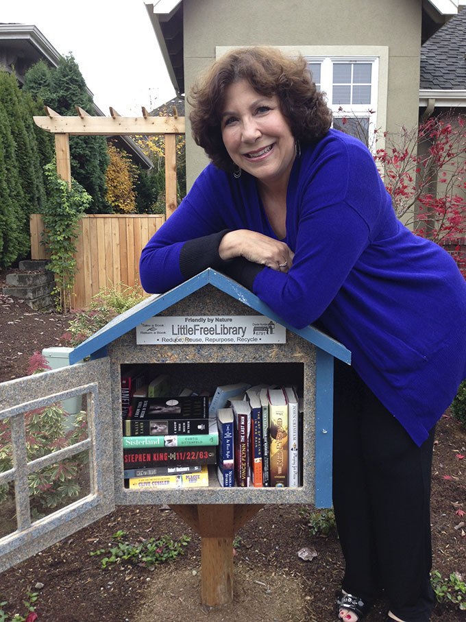 Best-selling author Robin Ryan poses with her Little Free Library in front of her Sammamish home.