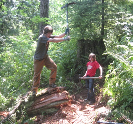 Eastside Catholic High School students Charlie Kittridge and Torey Stewart-Steele cutting trails on the Snoqualmie Reservation