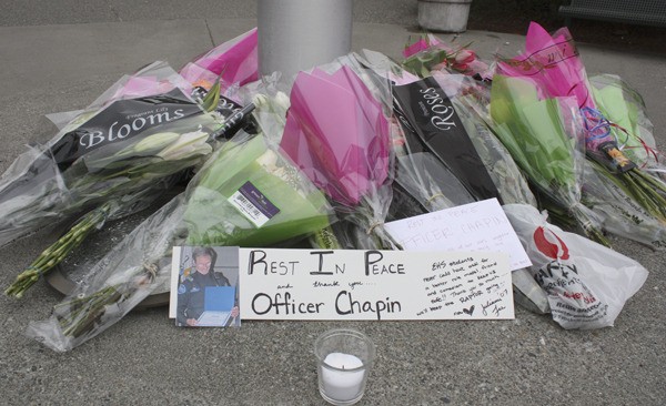 A memorial outside of Eastlake High School the day after Sammamish officer Stan Chapin passed away.