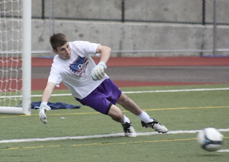 Issaquah freshman goalkeeper Evan King dives to make a stop in practice earlier this week. He is one of three goalies on this year’s roster head coach Jason Lichtenberger said has the skill to start.