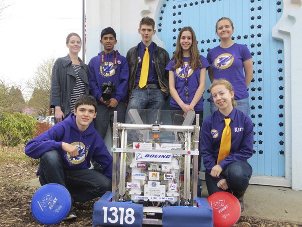 Members of the Issaquah Robotics Team - kneeling are Spencer Tickman and Kara Walker; standing from left are mentor Rebekah Jenkins