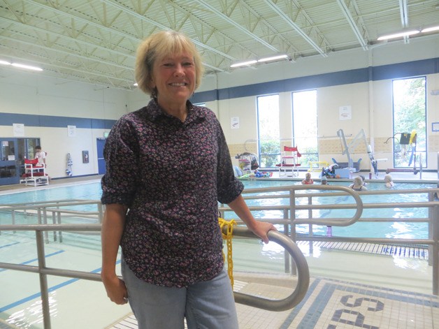 Harriet Ott stands near the warm-water therapy pool at the Bellevue Aquatic Center where she teaches classes.