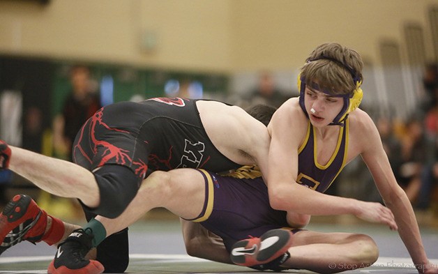 Issaquah 106-pounder William Tickman battles with Yelm's Mason Harrison in the finals of the Class 4A Region II tournament at Inglemoor High School in Kenmore. Harrison won the match 8-4.