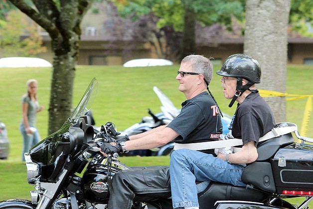 Grant Ringel gives Richard Ingertila a ride around the parking lot at Providence Marianwood.