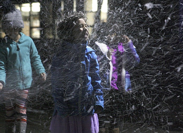 A layer of snow on her face and jacket