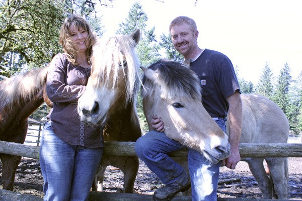 Kelly Bolen and Doug Madden stand with the two newest additions to Equine Escapes