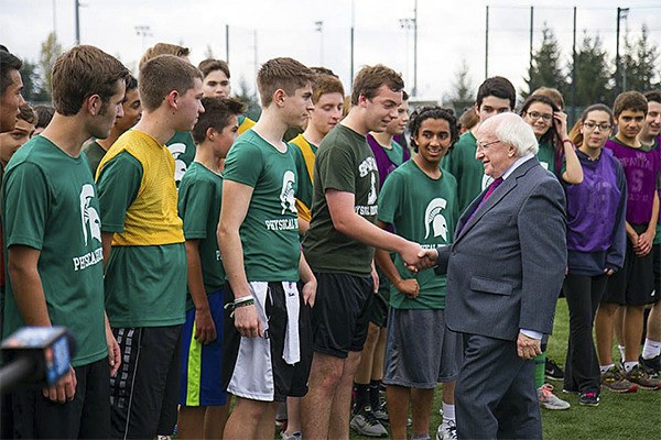 Irish President Michael Higgins shakes hands with a Skyline High School student during Higgins time on the Plateau to watch students play Gaelic football Oct. 22.