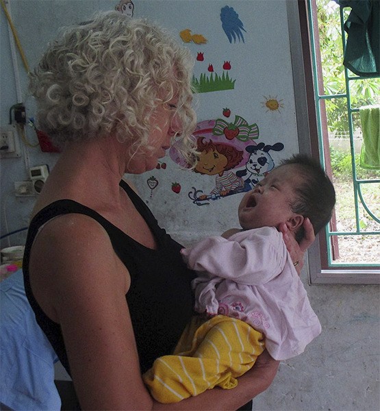 Dawn Sanders holds a sick infant in the Ba Vi Orphanage in Vietnam in October 2014. The longtime Sammamish resident and her husband have been living abroad in the country for a year and a half.