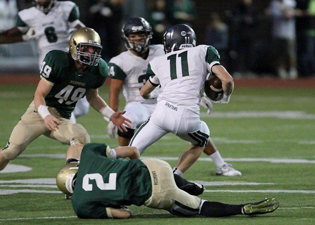 Skyline Spartans wide receiver Danny Sinatro tries to elude Redmond Mustangs defenders on Oct. 3. The Spartans defeated the Mustangs 59-0.