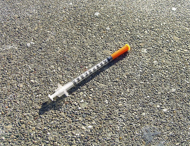 A discarded intravenous needle and syringe.