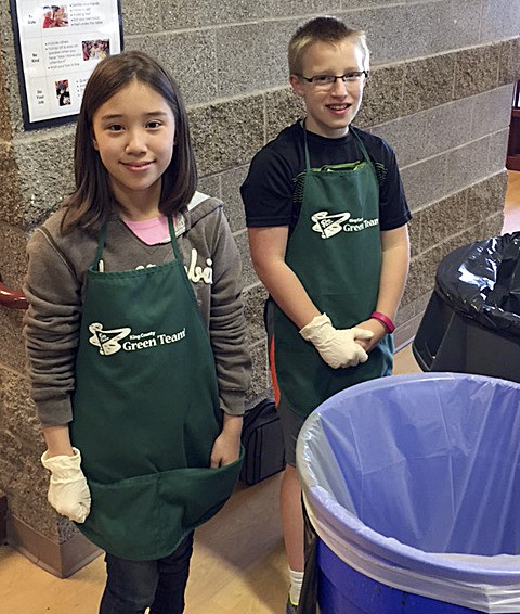 Cascade Ridge Elementary School students and green team members Elani Rocker and Lex Martinkosky help their peers sort trash from recyclable goods this year. Students have kept thousands of apple sauce and drink pouches out of the landfill since the school joined TerraCycle’s national recycling program last year.