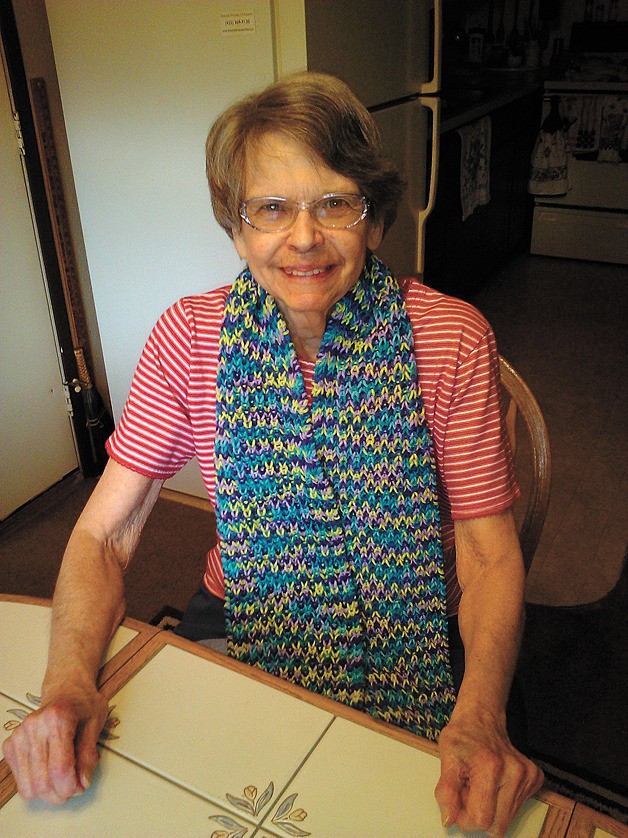 Issaquah resident Shirley Lambert wears her scarf made by local knitters.