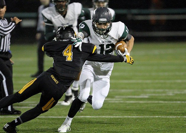 Skyline Spartans running back Logan Wanamaker tries to break free of a tackle attempt from Inglemoor's AJ Peacocke on Oct. 24 in Kenmore.