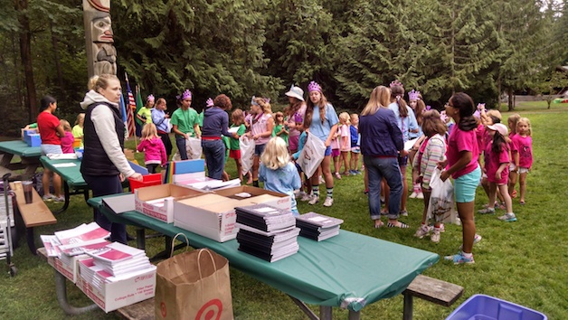 Local Girl Scouts at Girl Scout Sammamish Day Camp race to fill back to school kits to support kids in east King County. Kits included all items needed to start school.