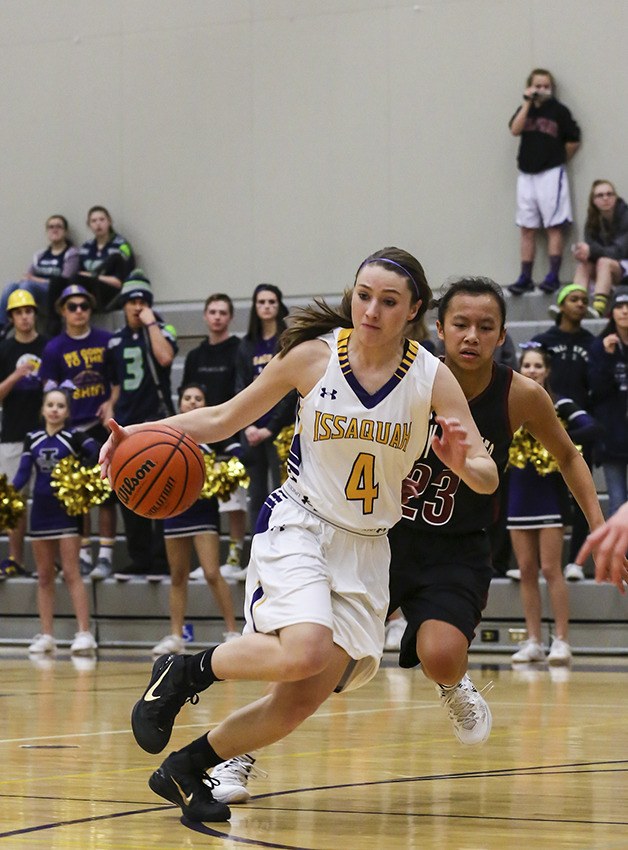 Issaquah guard Sophie Foreman drives to the hoop while being chased by Eastlake freshman Gina Marxen on Jan. 23 in Sammamish.