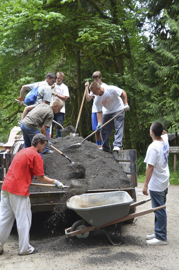 Eastside Catholic football players work at Camp River Ridge in Carnation.