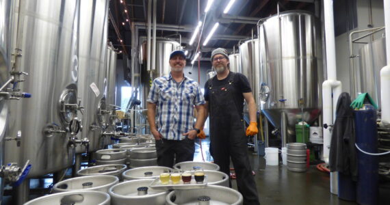 Danny Bohm (right) and Jesse Brown (left) stand over the four award-winning WBC beers in the manufactory portion of the brewery. (Cameron Sires/ Sound Publishing)