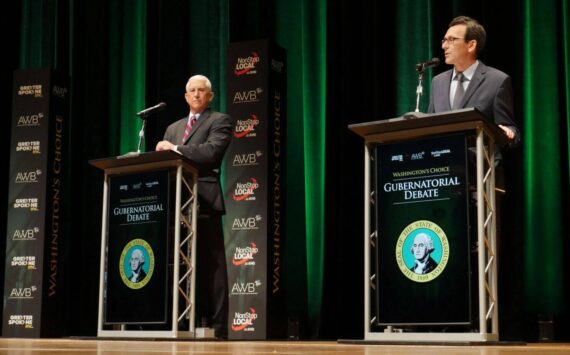 Former Congressman Dave Reichert, a Republican, left, and Washington state Attorney General Bob Ferguson, a Democrat, right, are seen on stage during the second debate of the 2024 Washington state governor’s race, Sept. 18, 2024, in Spokane, Wash. (Bill Lucia/Washington State Standard)